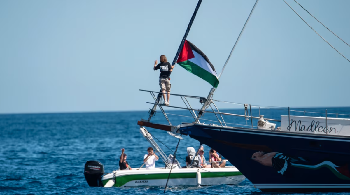 Greta holds a Palestinian flag before setting sail for Gaza.